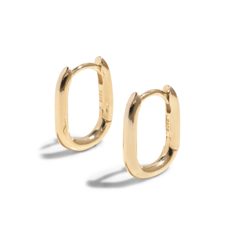 Gold oval hoop earring with a sleek and polished finish, featuring a secure hinge closure. This packshot highlights its modern and minimalist design.