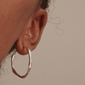 silver hoop uneven bamboo style hoops earrings 
