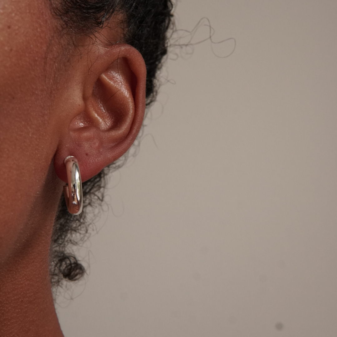 Chubby sterling silver hoop in an ear