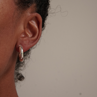 Chubby sterling silver hoop in an ear