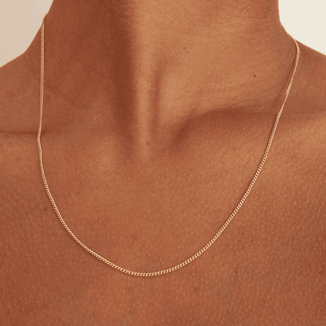 Thin gold necklace chain on brown skin in 45cm