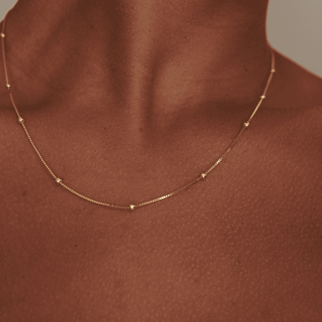 Gold necklace on brown skin