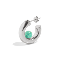 a silver hoop earring with a green quartz gemstone positioned inside the open hoop