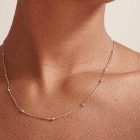 silver necklace also known as box chain necklace with beads on model