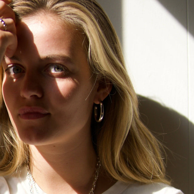 Blonde girl with silver hoop earrings