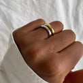 a close up of a person with Set of two rings in gold and silver with smooth, irregular bands, offering a modern twist on classic styles. These stack of rings showcases the minimalist and versatile design, perfect for stacking or wearing individually.