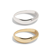 "Set of two rings in gold and silver with smooth, irregular bands, offering a modern twist on classic styles. This packshot showcases the minimalist and versatile design, perfect for stacking or wearing individually.